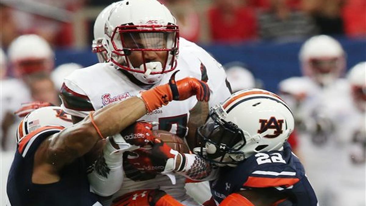 Louisville wide receiver Jaylen Smith (87) is hit by Auburn defensive back Tim Irvin (22) during the first half of an NCAA college football game, Saturday, Sept. 5, 2015, in Atlanta.