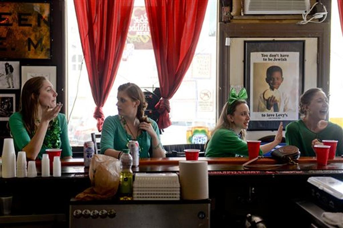 People drink at Pinkies Master’s Lounge in Savannah, Ga., Saturday, March 14, 2015.