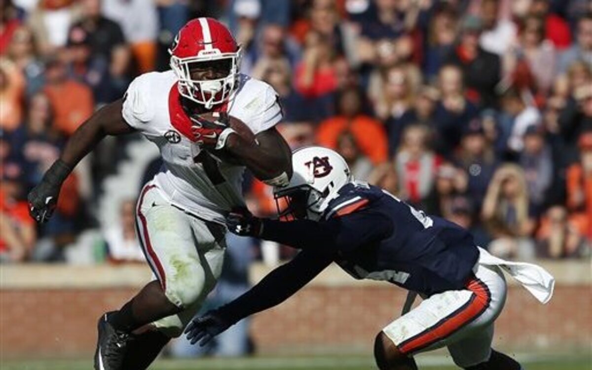 Georgia running back Sony Michel (1) carries the ball for a first down as he gets past Auburn defensive back Derrick Moncrief (24) during the second half of an NCAA football game, Saturday, Nov. 14, 2015, in Auburn, Ala. Georgia won 20-13.