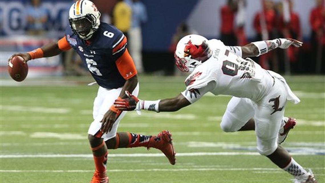 Louisville linebacker Devonte Fields (92) chases Auburn quarterback Jeremy Johnson (6) during the first half of an NCAA college football game, Saturday, Sept. 5, 2015, in Atlanta. Auburn won 31-24.