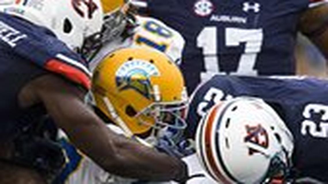 San Jose State wide receiver Hansell Wilson (87) fumbles the ball against Auburn defensive back Johnathan Ford (23) and Auburn linebacker JaViere Mitchell (16) during the first half of an NCAA college football game, Saturday, Oct. 3, 2015, in Auburn, Ala.